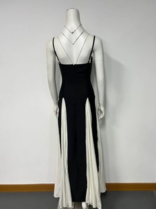 Detail of contrast pleats and backless design on a black and white midi dress