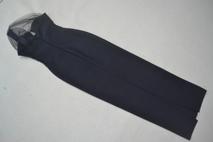 Detail of the mesh splicing neckline and invisible zipper on the black slim bandage dress