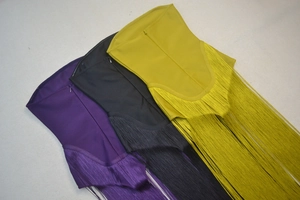 Close-up of tassel fringe and invisible zipper detail on cocktail bandage dresses