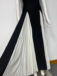 Detailed close-up of contrast black and white pleated patchwork on a slim fit maxi dress