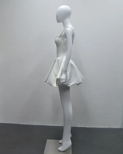Détail de la robe mini blanche avec encolure carrée perlée et jupe bouffante en satin