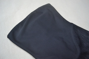 Detail of high-elastic black fabric with precision curved stitching and smooth finish