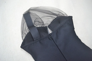 Detail view of black bandage dress featuring mesh panels and an invisible back zipper