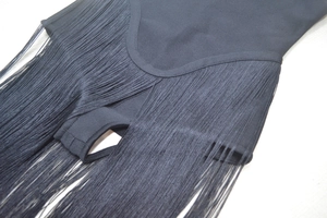 Close-up of premium black strapless bandage dress featuring dense hanging fringe details