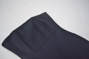 Detail of the black strapless dress bodice featuring structural seams and high-quality fabric