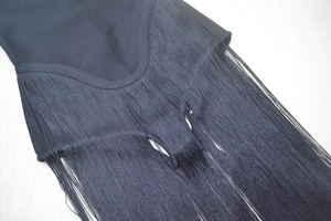 Detail of dense black fringes on a chic bandage dress for party and fashion events