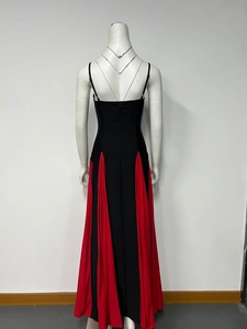 Detail of slim-fit dress showing back invisible zipper and pleated red hem contrast