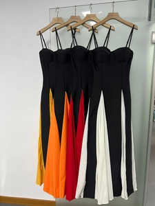 Detail view of bodycon midi dresses featuring contrast color patchwork hems and straps