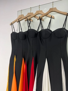 Detail of color-block pleated hems on elegant bodycon midi dresses with spaghetti straps