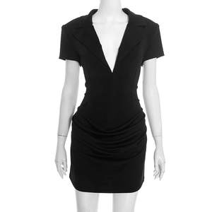 Close-up of the elegant deep V-neckline and pleated waist detail on the black slim fit dress