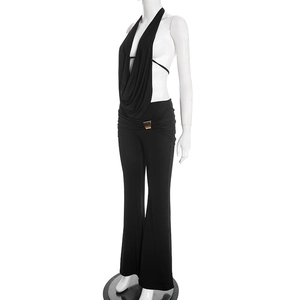Detail von schwarzem Neckholder-Top und Schlaghose mit eleganter goldener Schnalle