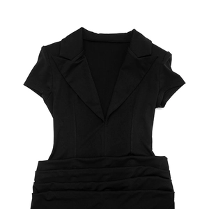 Detail view of black V-neck dress with pleated waist and sharp blazer-style lapels