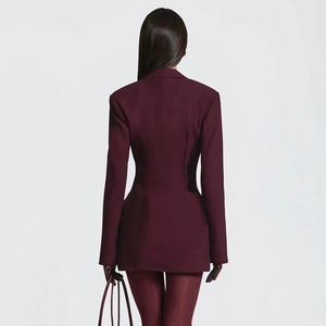Detail view of the back of a slim-fit burgundy blazer dress with elegant tailored waistline