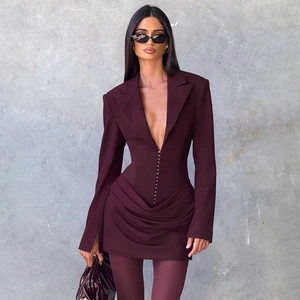 Detail view of the deep V-neckline and elegant draped pleats on the burgundy dress