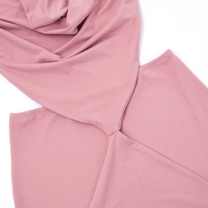Detail of pink knitted dress featuring hollow-out side cut and cross knot craftsmanship
