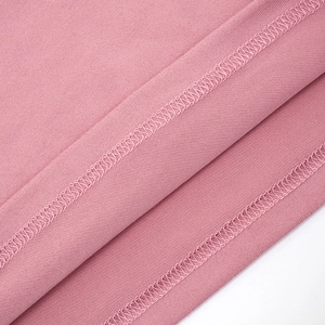 Detailed close-up showing flatlock stitching and knit fabric texture in dusty rose pink