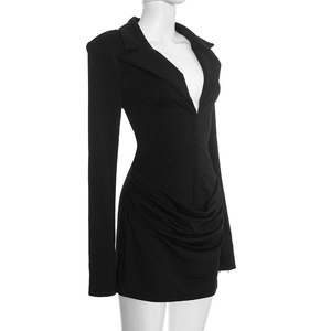 Detail view of ruched fabric and slim fit design on black long sleeve mini dress