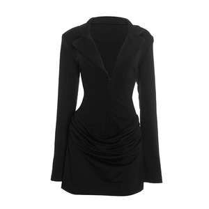 Detail of elegant black blazer dress featuring sophisticated waist ruching and lapel
