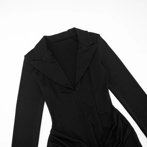 Detailed view of women's black long sleeve mini dress with V-neck and ruched details