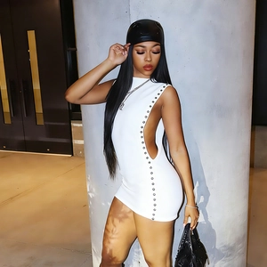 Close-up of white mini dress featuring side cut-outs and silver metal rivet detailing