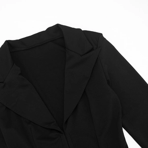 Detail of the notched lapel and v-neckline on a black elegant slim fit blazer dress