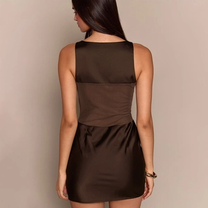 Detail of slim fit backless chocolate satin mini dress with elegant mesh stitching