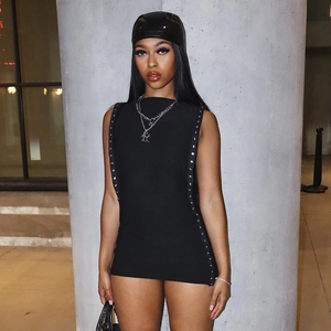 Detail of silver metal eyelet studs on a black sleeveless bodycon dress for women