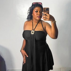 Elegant black halter mini dress with a gold metal ring and stylish pleated detail