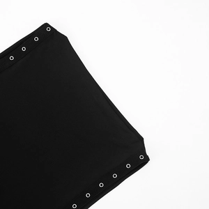 Close-up detail of silver metal grommets on high-quality black knitted sleeveless dress