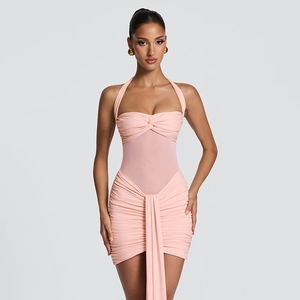 Detail of peach pink halter neck dress featuring mesh patchwork and pleated draping