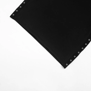 Detail of black fabric with symmetrical silver metal eyelets and premium stitching texture