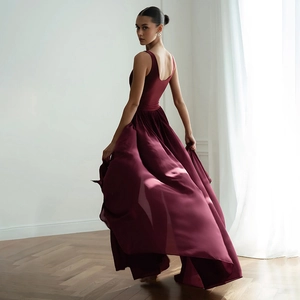 Elegant maroon sleeveless chiffon maxi dress with high waist and flowing slit skirt