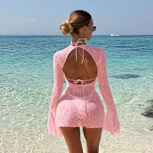 Back view of pink lace crochet beach dress with cross-straps and open back design