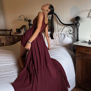 Detailed texture of burgundy sleeveless chiffon dress with side slit and pleated skirt