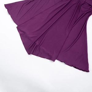 Detail of deep purple dress hem showing high elasticity fabric and draped texture