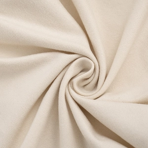 Vue macro détaillée de la texture du tissu en maille beige doux et du matériau élastique