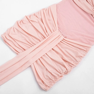 Detail of light pink mesh dress featuring elegant ruching and side streamers