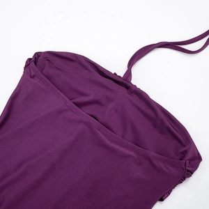 Detail of purple halter neck ties and subtle side ruching on an elegant sleeveless dress