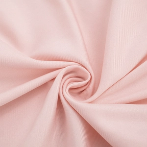 Close-up of light pink ribbed knit fabric detail showing soft texture and fine vertical stripes