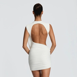 Close-up of ruched white bodycon dress featuring open back and asymmetric drape