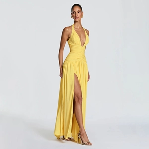 Detail of elegant bright yellow halter neck maxi dress with deep V-neck and high leg slit