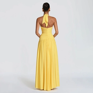 Elegant bright yellow halter neck backless maxi dress with ruched details and pleated skirt