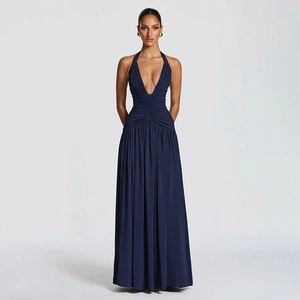 Detail of elegant dark blue halter maxi dress with deep V-neck and ruched waist detail