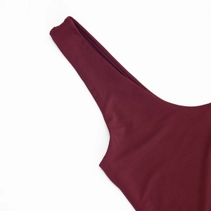 Detail view of burgundy wine red dress showing seamless stitching and smooth elastic fabric