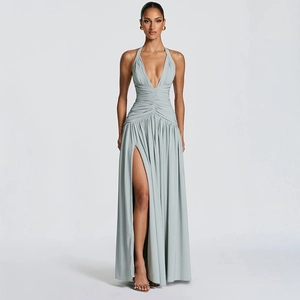 Detail of sage green halter neck dress showing the deep V-neckline and elegant waist pleats