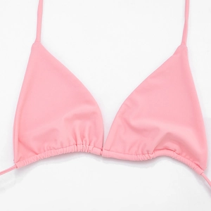 Detailed view of pink triangle bikini top with ruched texture and slim adjustable straps