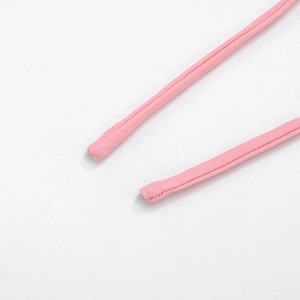 Close-up of pink bikini string straps with detailed stitching and soft knit fabric texture