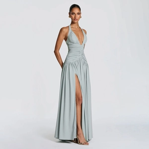Detail showing deep V-neck and pleated waist on a sage green halter neck slit maxi dress
