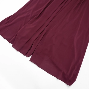 Detail shot of the burgundy chiffon dress showing its smooth hem and high-quality stitching