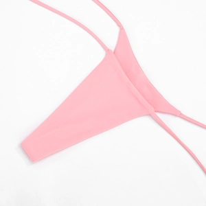 Close-up of pink minimalist bikini bottoms with ultra-thin side straps and high-stretch fabric